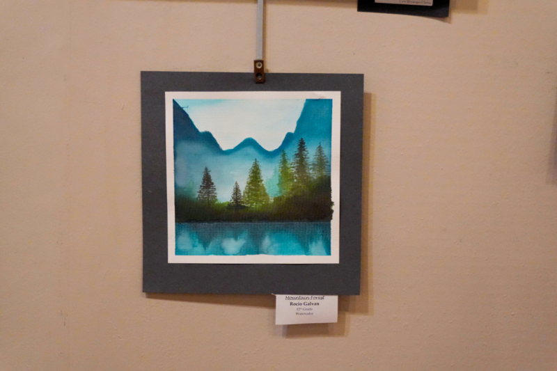 Watercolor art of a lake in the mountains.