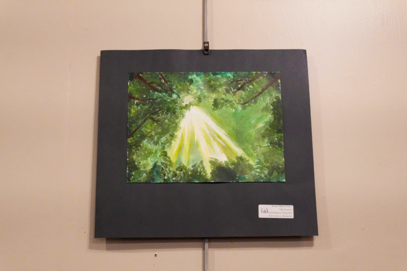 Watercolor art of god rays peaking through the leaves of a tree.