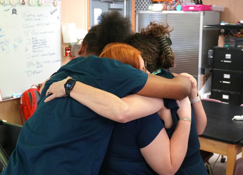 ACCTC biomedicine students hug Dr. Palladino, who leads the program.