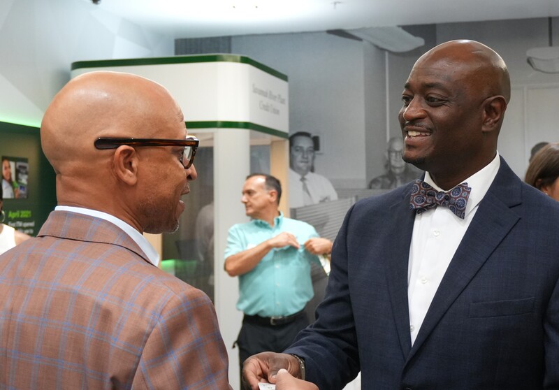 Dr. Corey Murphy shakes hands with a community leader.