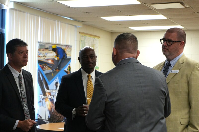 District and school leaders talk in a huddle.