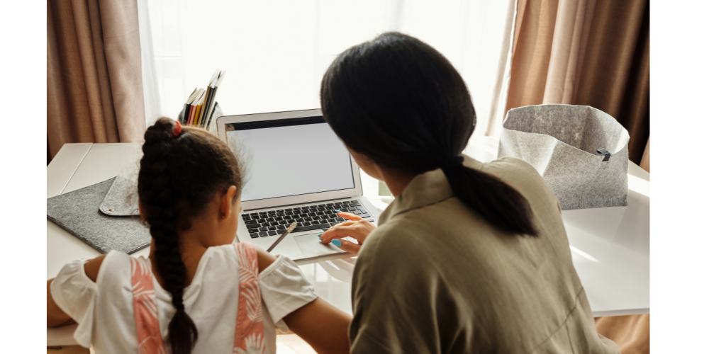 ADULT AND STUDENT ON LAPTOP