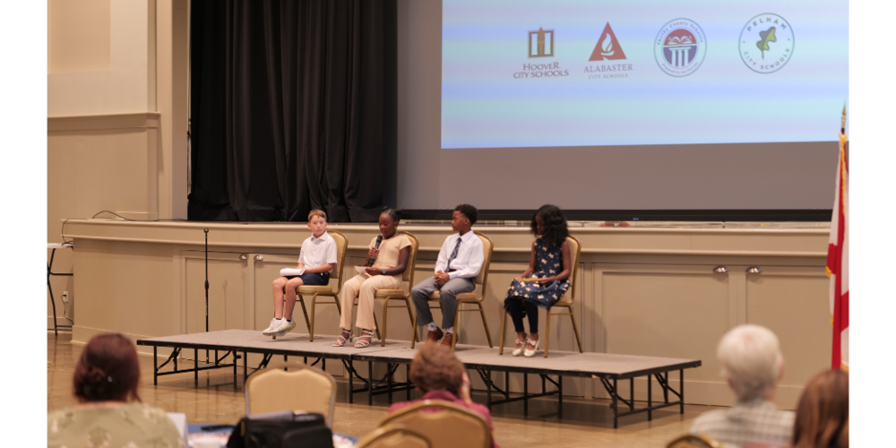 FOUR STUDENTS ON STAGE