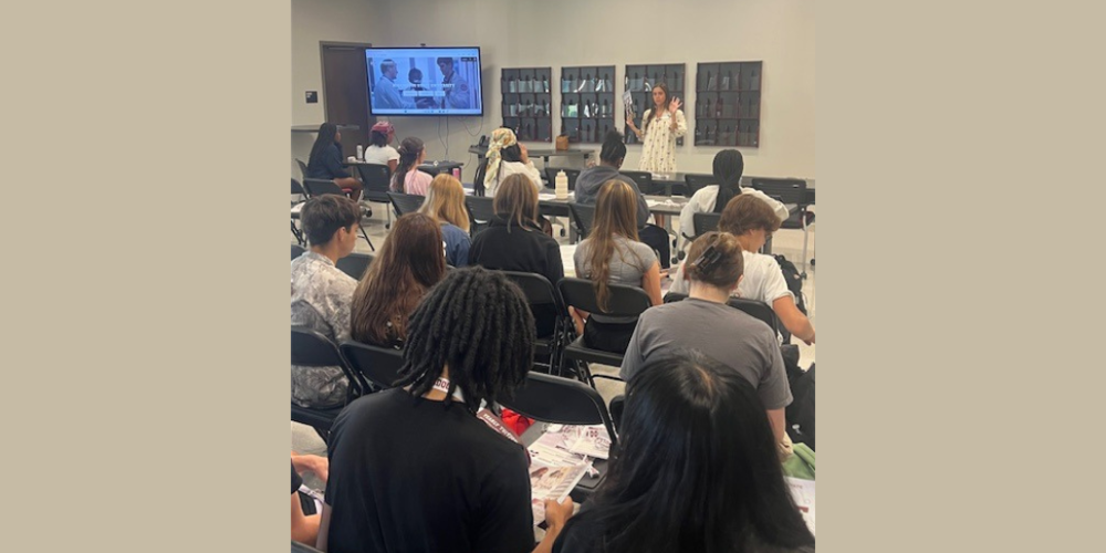 students listening to adult present in a classroom setting