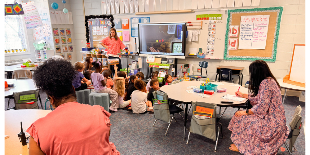 TEACHER TEACHING AND BEING OBSERVED BY OTHER ADULTS