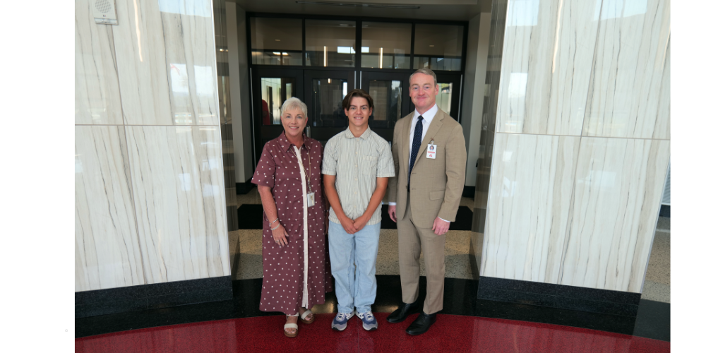 TWO ADULTS AND ONE STUDENT IN SCHOOL LOBBY