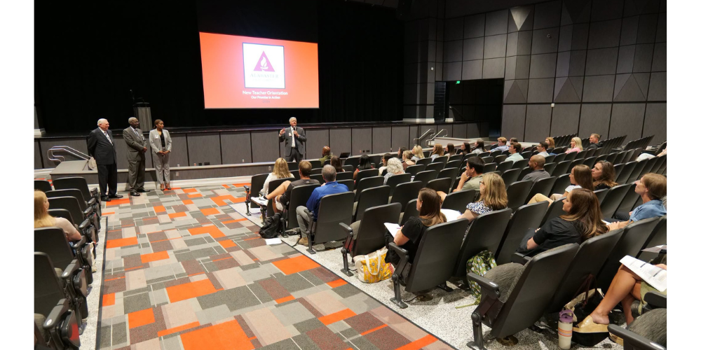 man addressing audience in auditorium