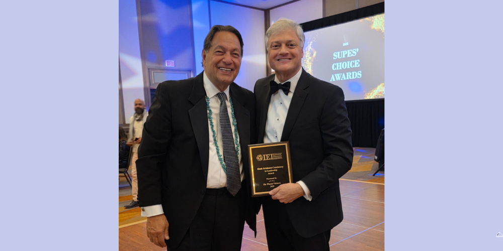 TWO MEN IN SUITS; ONE HOLDING AWARD