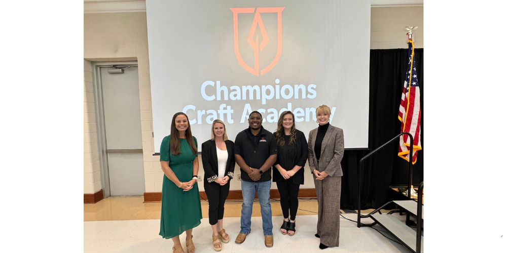 five students standing and holding awards certificates