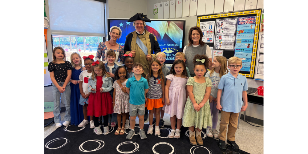 GROUP OF STUDENTS WITH TEACHER AND HISTORICAL CHARACTERS