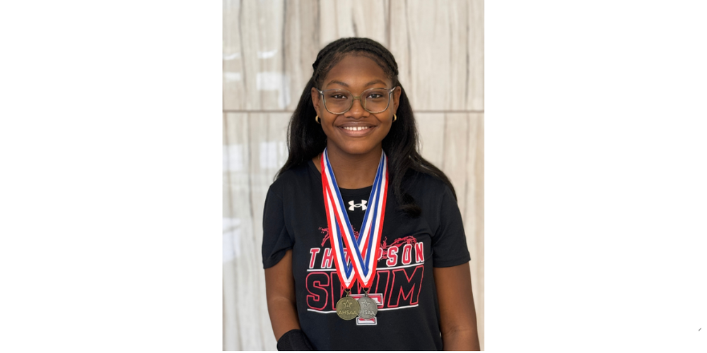 ZOE MOORE WITH GOLD AND SILVER MEDALS AROUND NECK