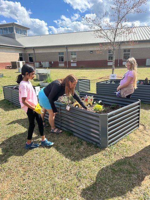 students working in outdoor garden