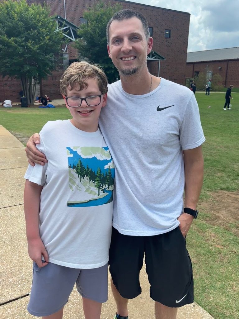 teacher and student posing for photo
