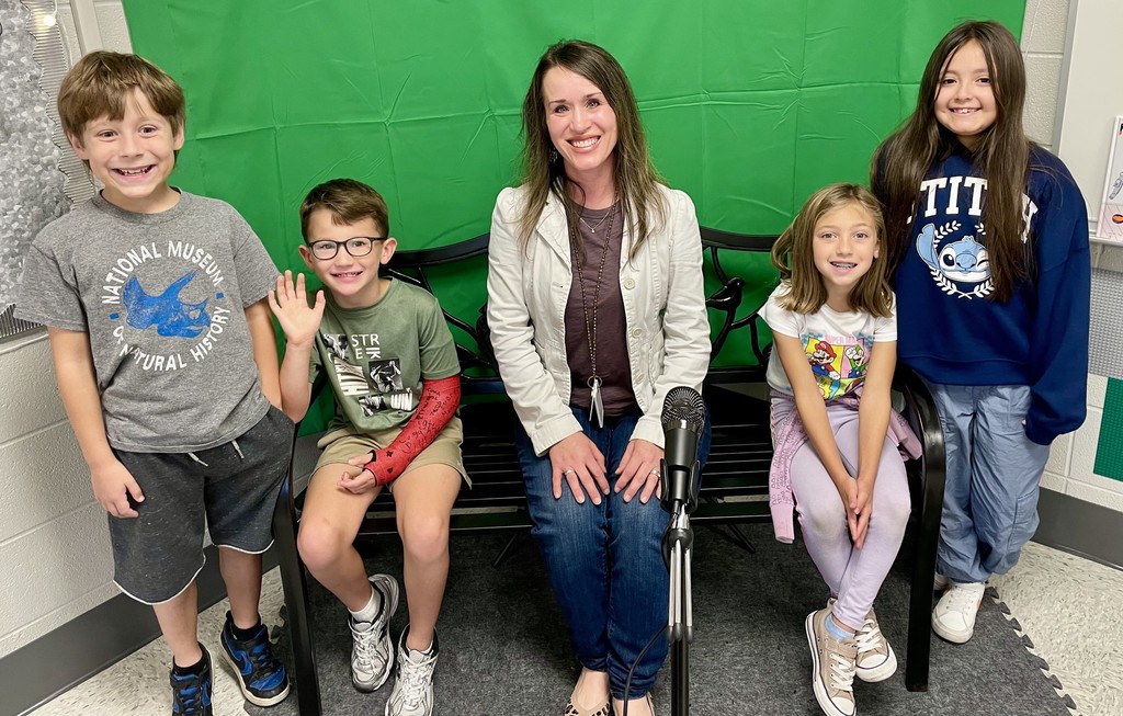 School counselor posing with children on the morning news