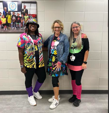 3 women dressed up from the 80's