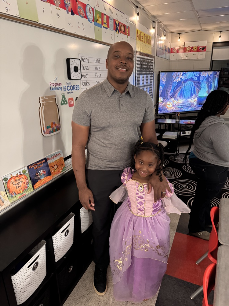 A father and his daughter in a classroom