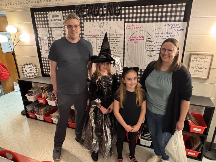 A family of four in a classroom