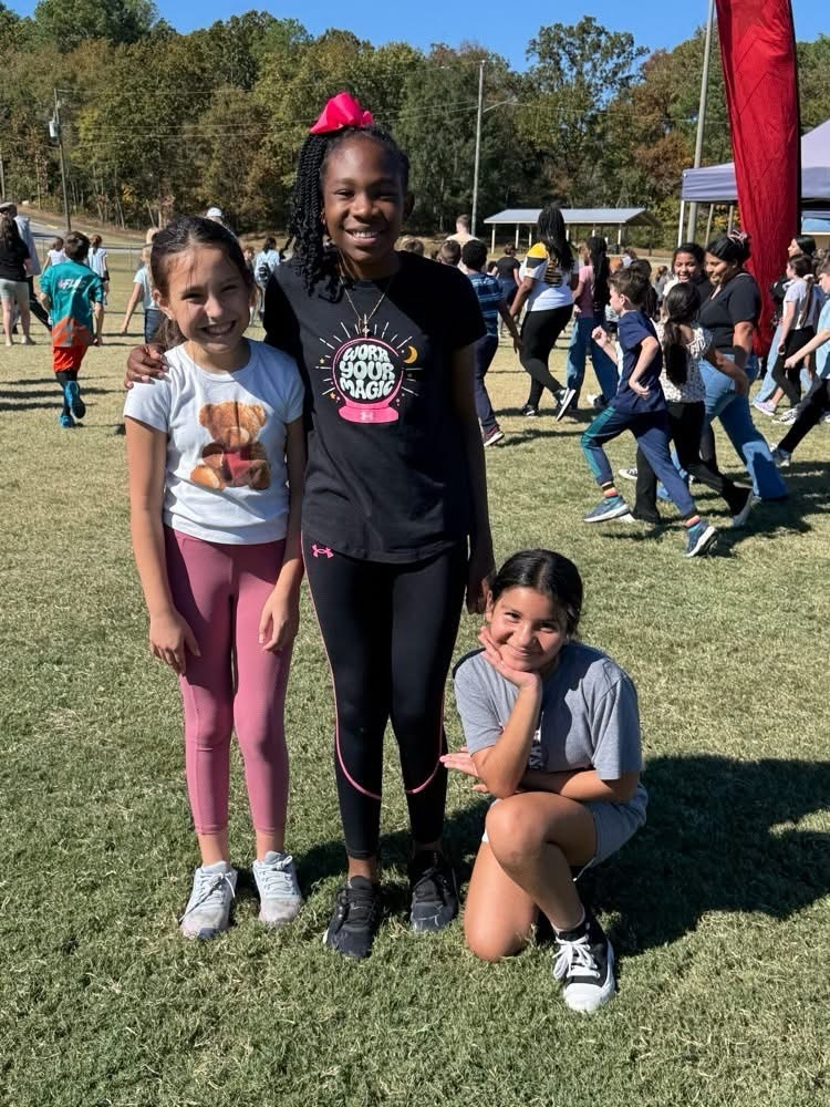 three students in a field