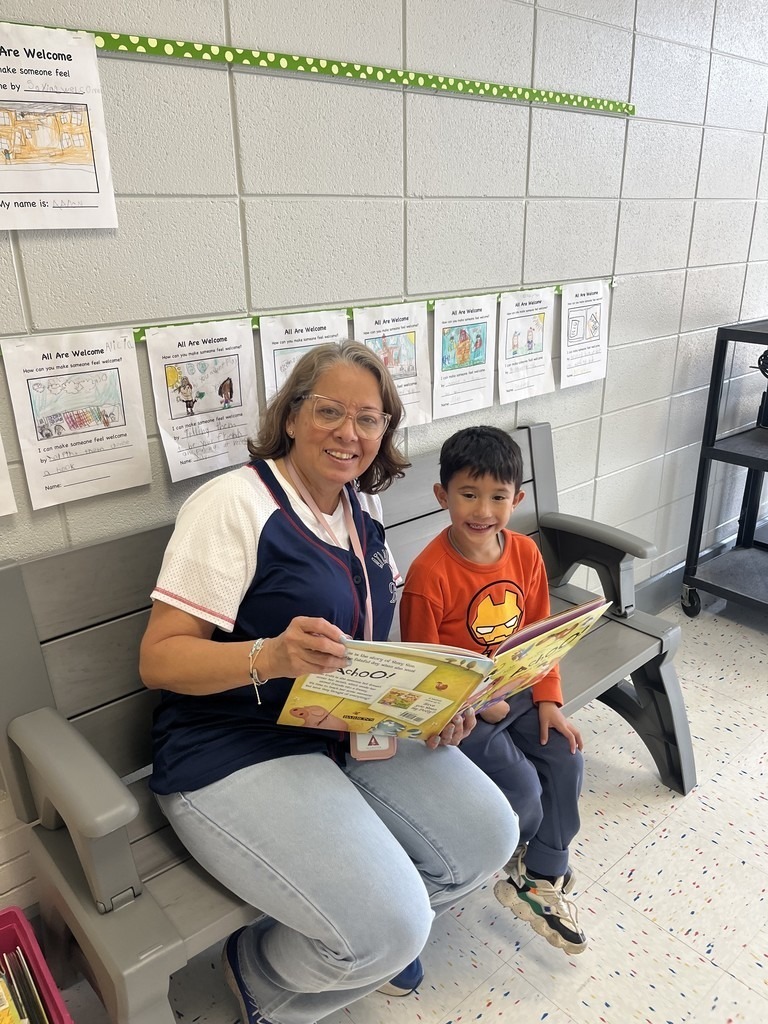 teacher working with student in school hallway