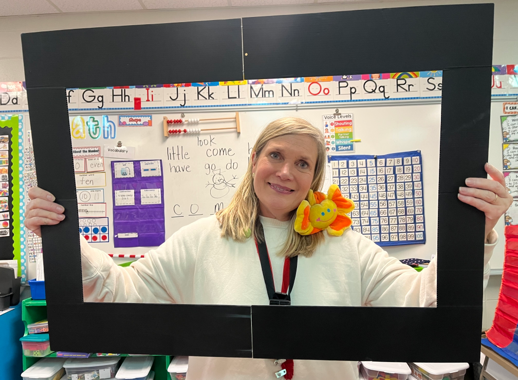 ms. schmidt holding marigold sign