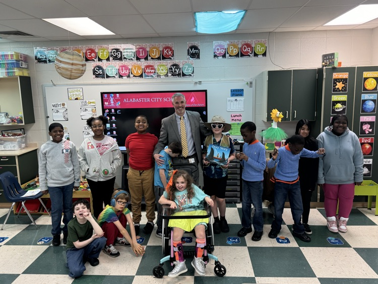 man with students in a classroom