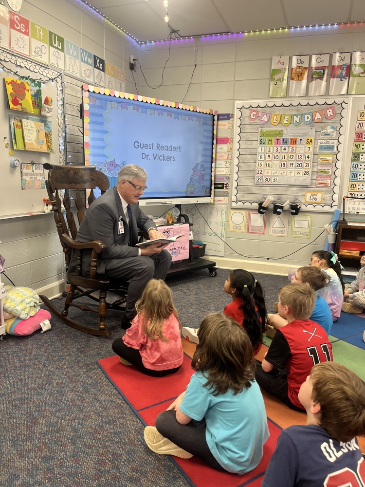 Man reading to a group of student