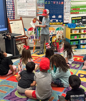 a student reading to a class