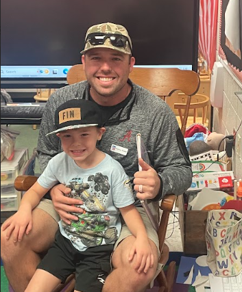 dad and son wearing hats after reading a book