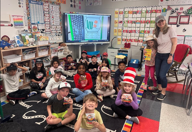 mystery reading posing with class wearing hats