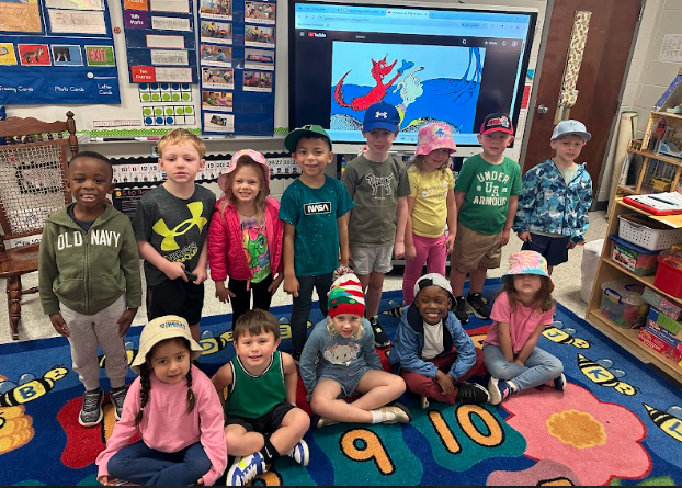 a class smiling wearing their hats for hat day