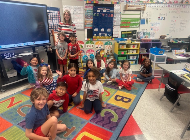 ms. maddox smiling with a class after reading a book