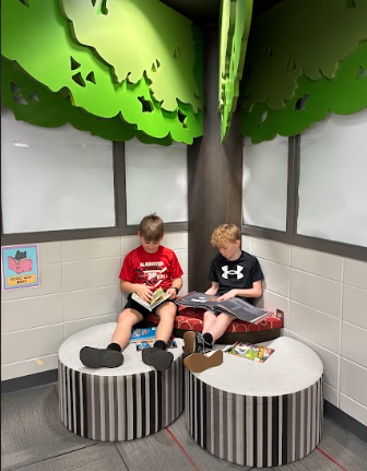 students reading by a tree