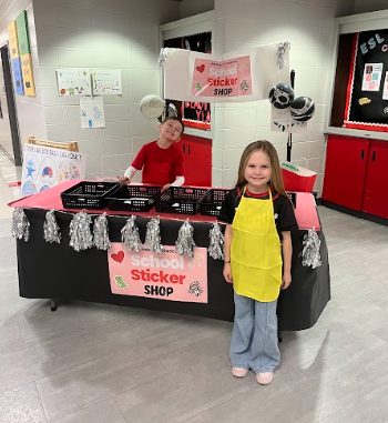 students in front of sticker booth