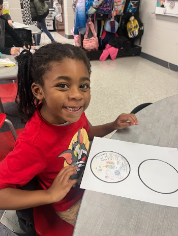 little boy smiling with his sticker design