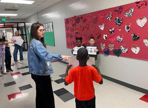 ms. rabu helping students make a video