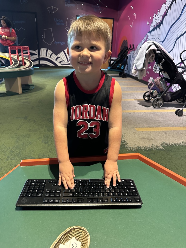 little boy typing on keyboard