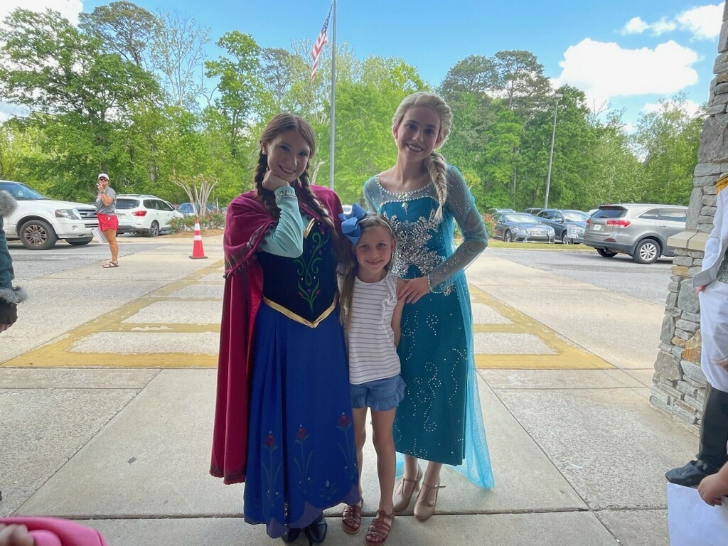 little girl smiling with anna & elsa