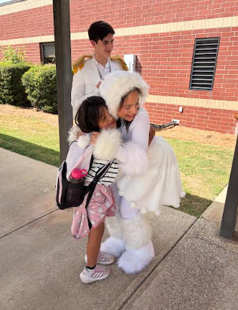 little girl hugging a snowman