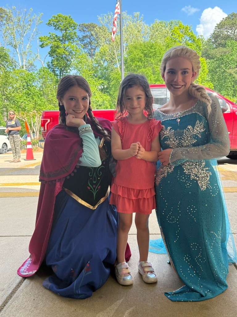 little girl smiling with anna & elsa