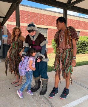 little girl hugging characters from frozen