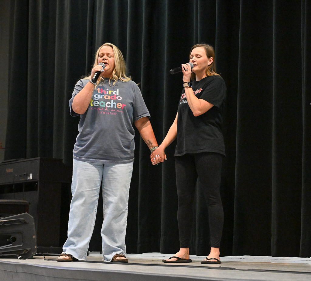 grillo and lawley holding hands singing