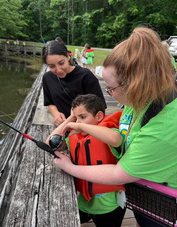 ms ellis helping a boy fish