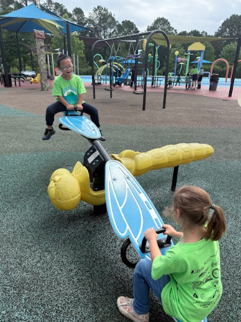 2 kids playing on seesaw