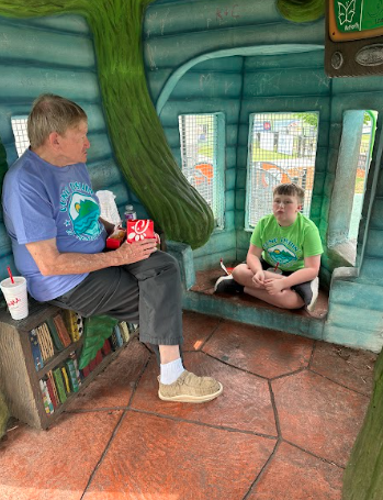 little boy sitting with grandfather