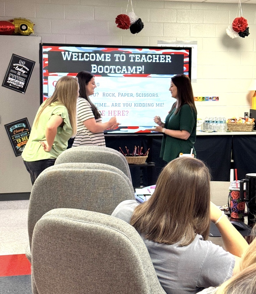 four teachers learning and instructing inside classroom