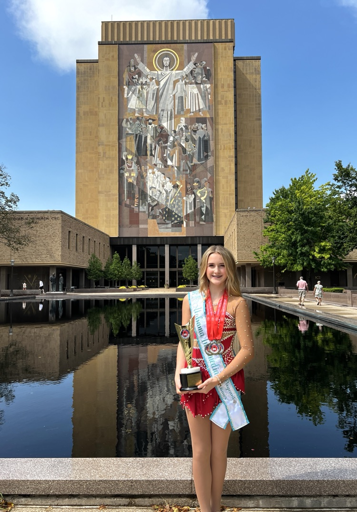 Majorette holding trophy outside