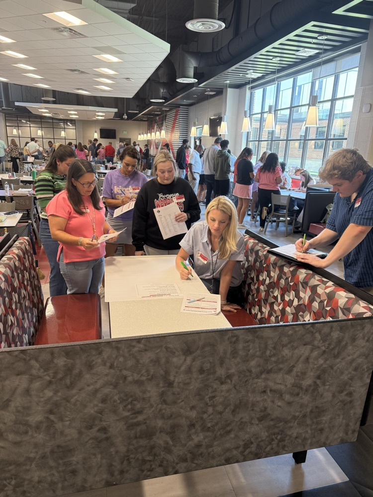 teachers engaged in professional development, large group of about 30 to 40 new teachers