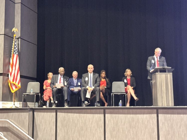 Multiple people sitting on stage