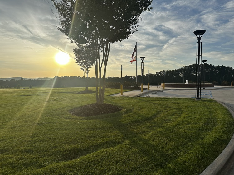 Beautiful sunrise coming across a lawn