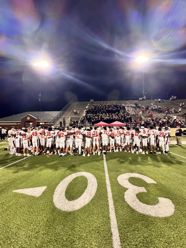 football players and band celebrating win